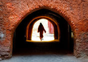  Woman walking through red tunnel, Marrakech